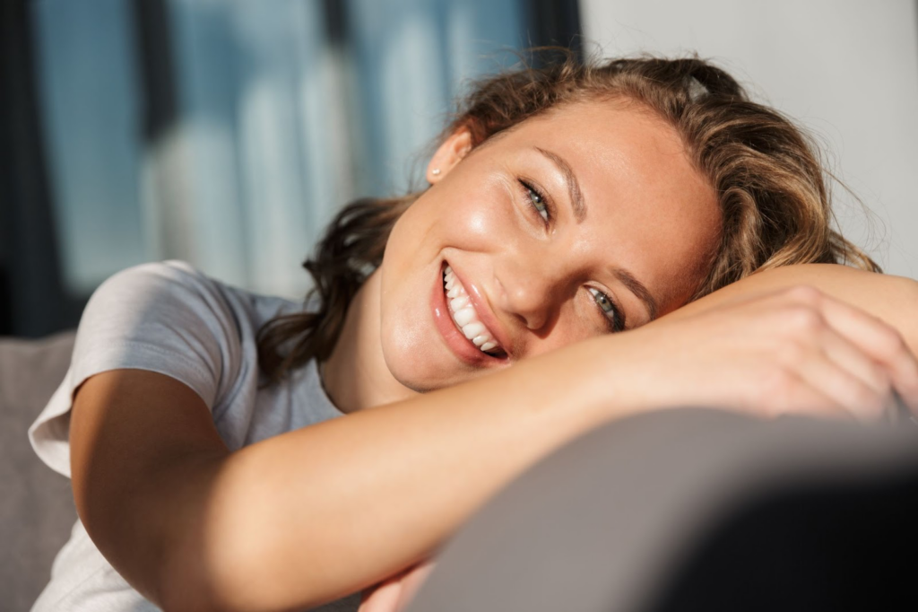 woman smiling in sunshine with white teeth
